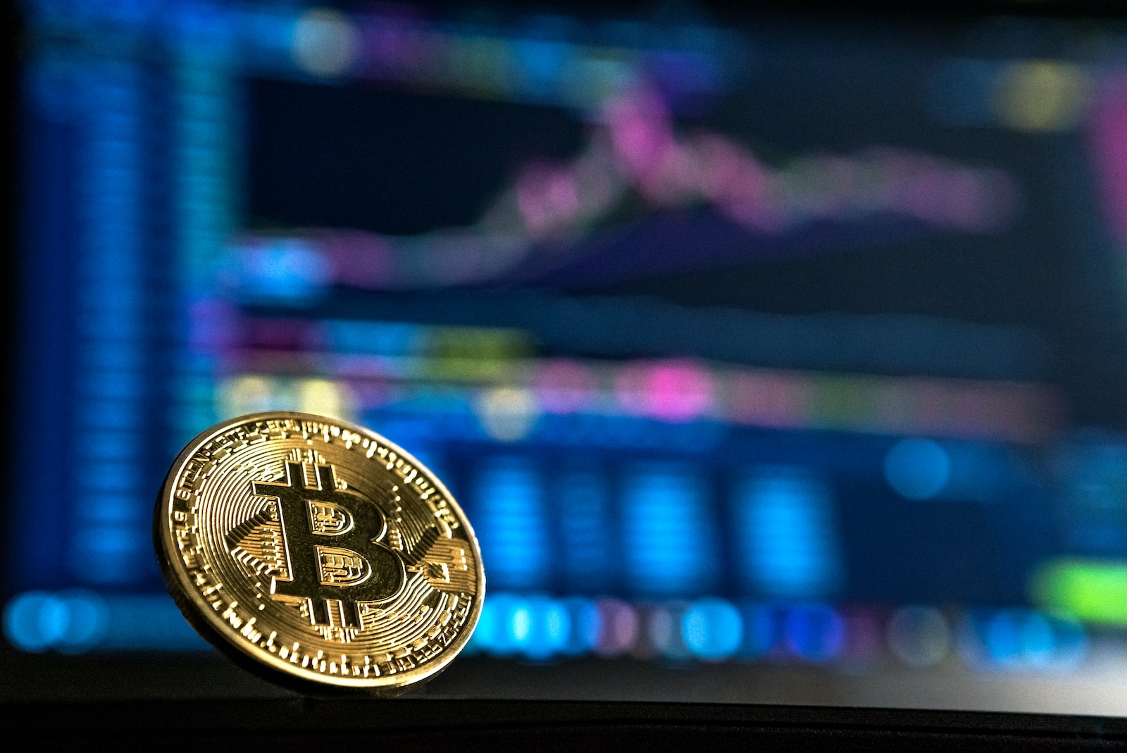 Gold Bitcoin on computer data background