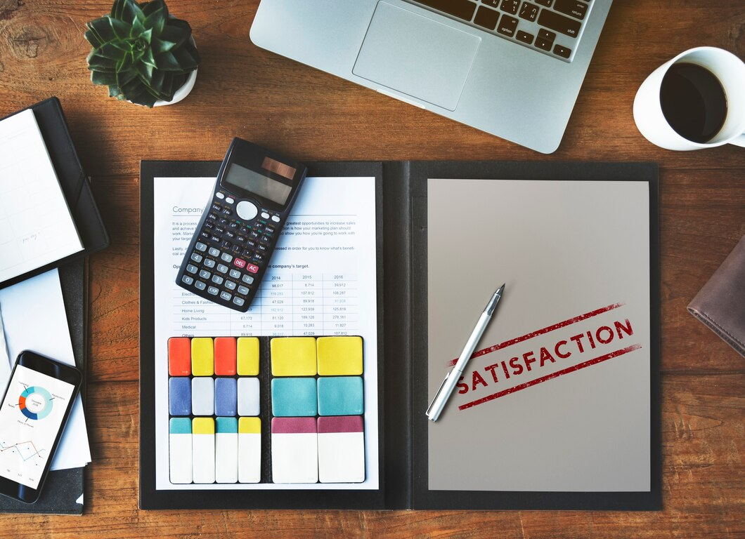 The word "satisfaction" is written on a piece of paper resting on a wooden desk